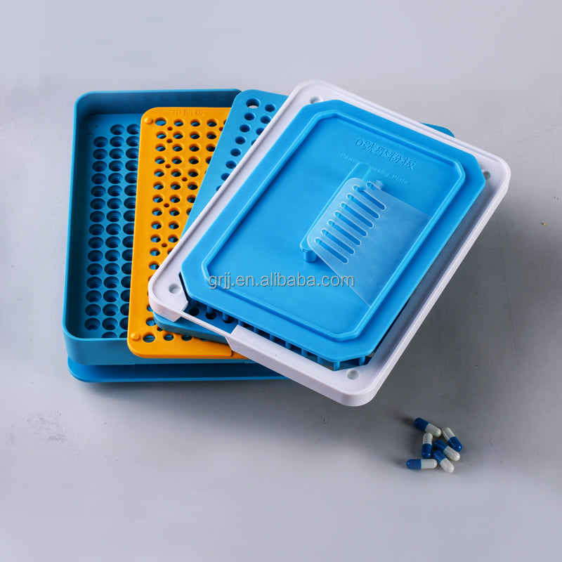 200-hole capsule tray with filled capsules and jar