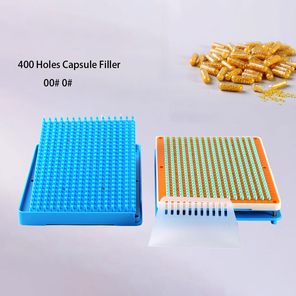 Hands loading capsule tray on 400-hole filler