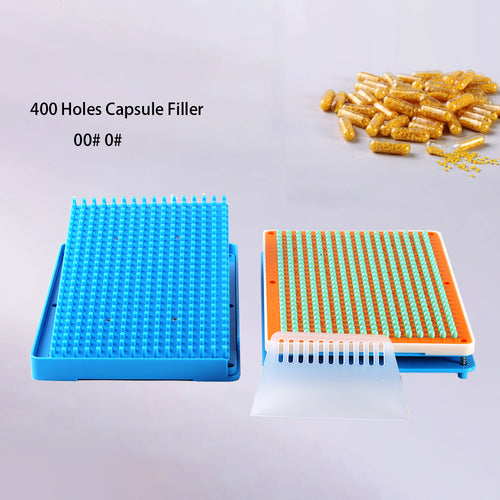 Hands loading capsule tray on 400-hole filler